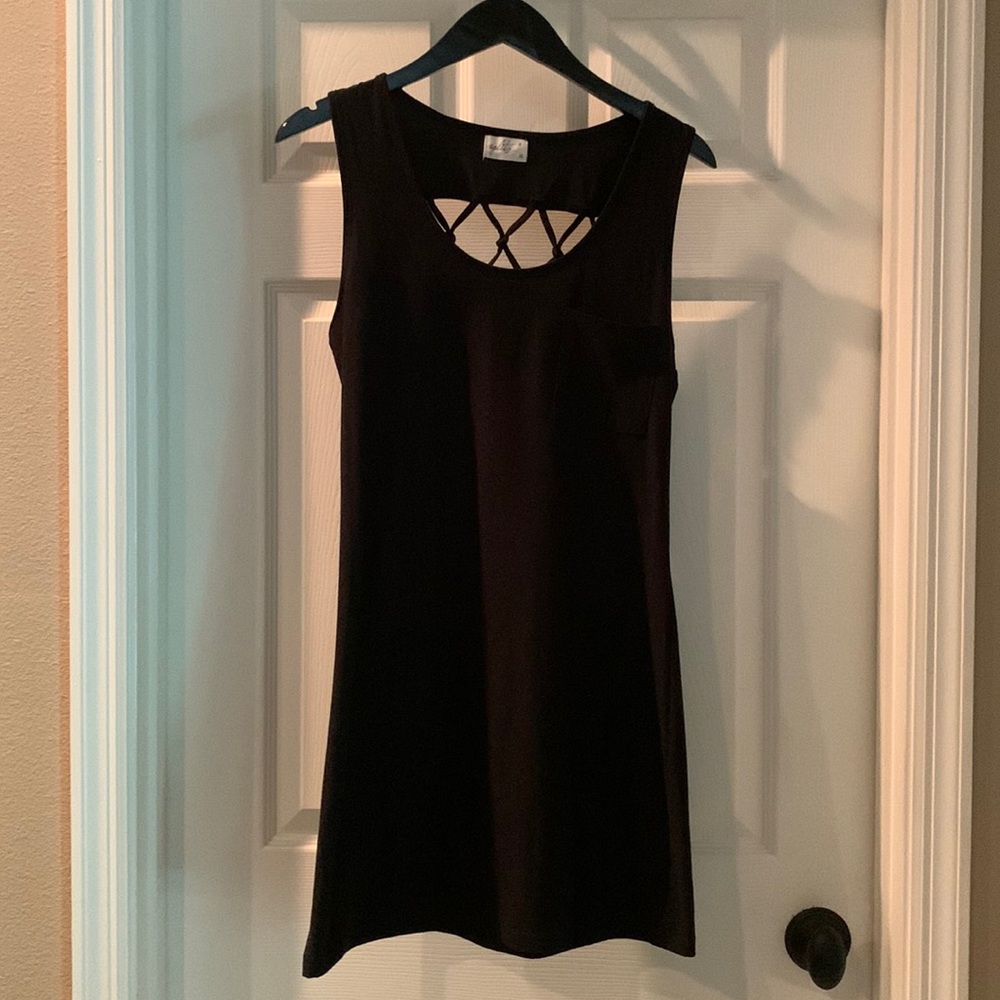 Black mini dress with detailing on back. Says size XL but it’s more of med fit.